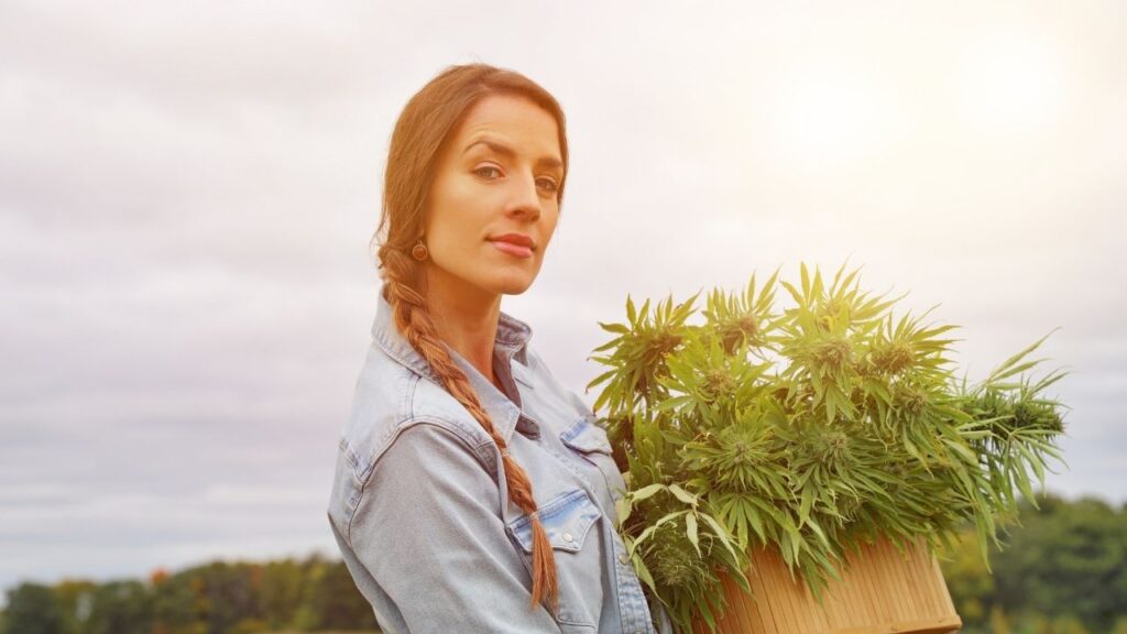 Girl Holding Cannabis Plant